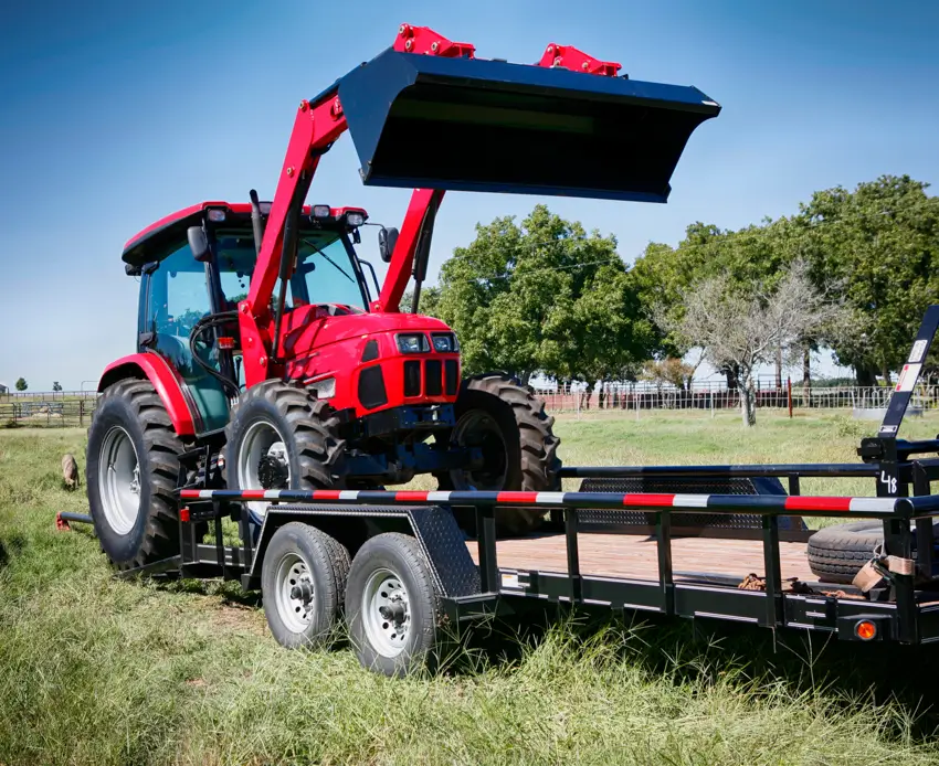 Tractor being towed by trailer